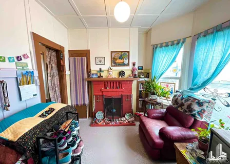 a bedroom with furniture and a fireplace