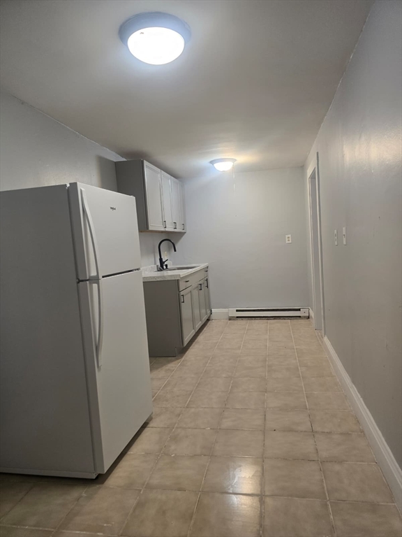 a view of a kitchen with a refrigerator washer and a fridge
