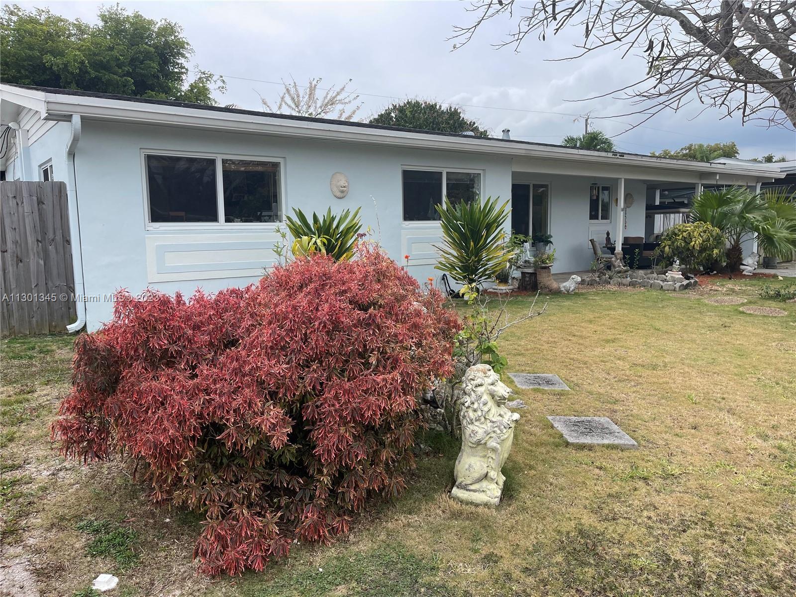 9520 April Road Cutler Bay, FL 33157 - Photo 1 of 26 a front view of house with yard and trees around