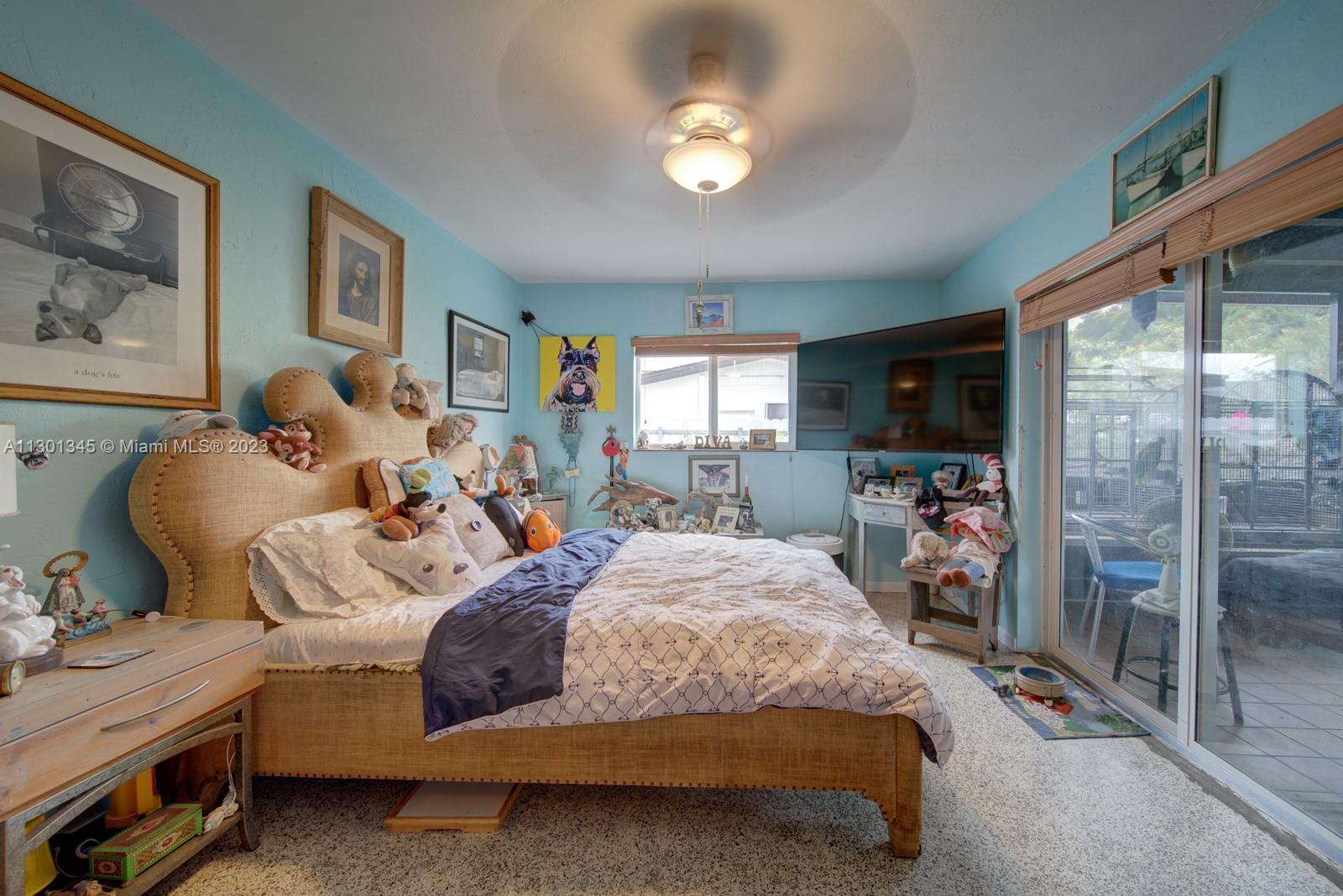 9520 April Road Cutler Bay, FL 33157 - Photo 15 of 26 a bed room with a bed and a tv