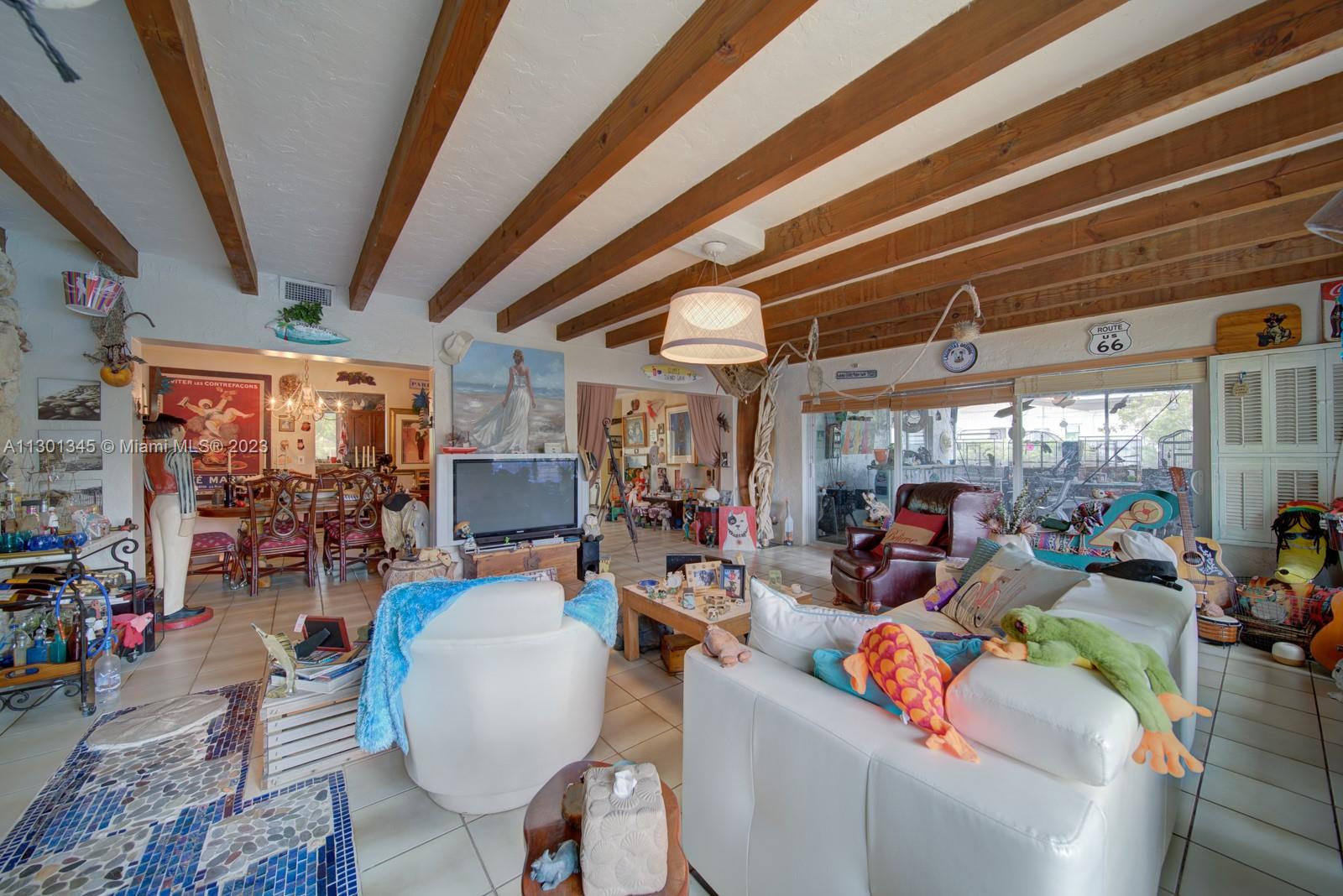 9520 April Road Cutler Bay, FL 33157 - Photo 22 of 26 a room with lots of tables a large window and chairs