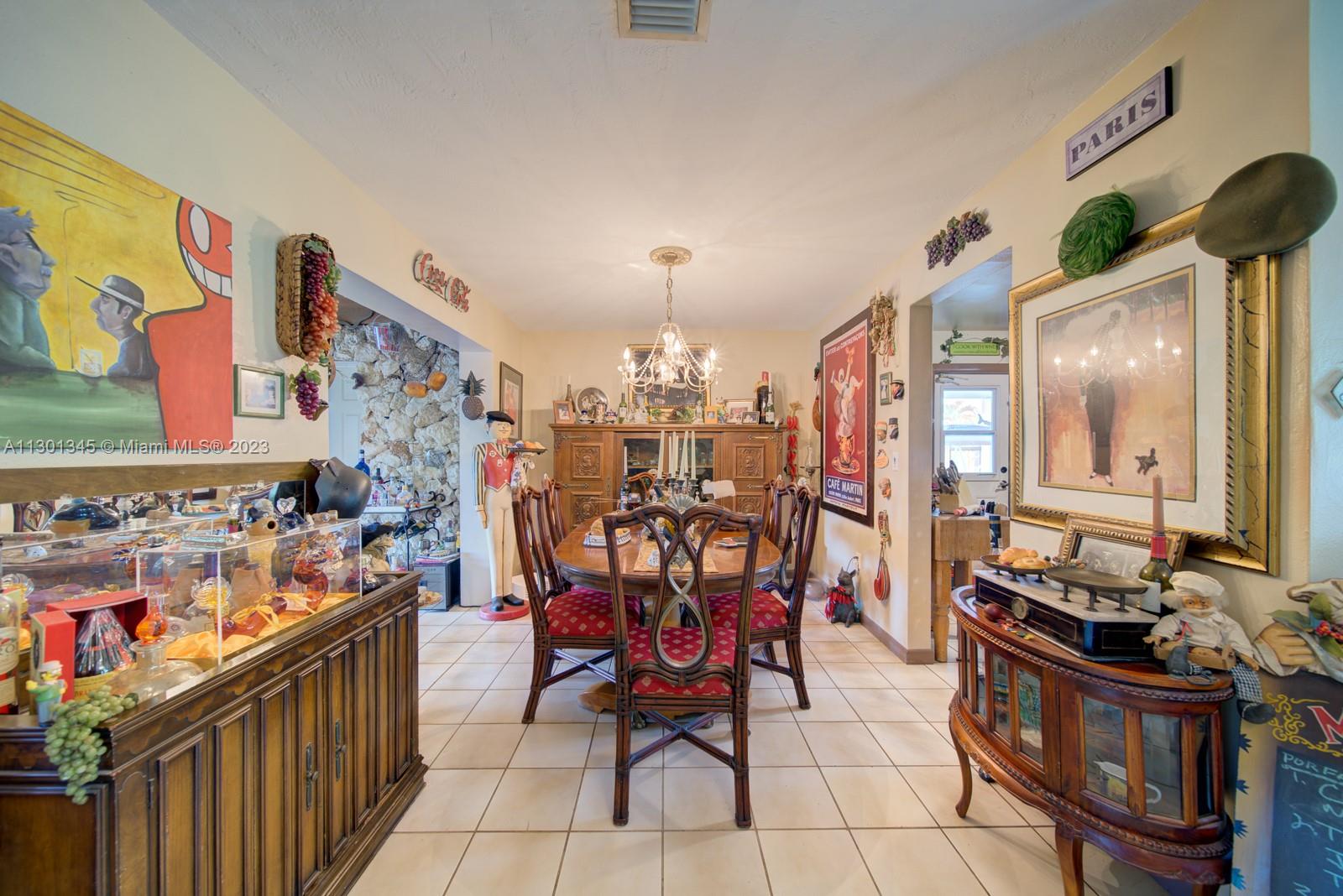 9520 April Road Cutler Bay, FL 33157 - Photo 24 of 26 a view of a dining room with furniture and chandelier