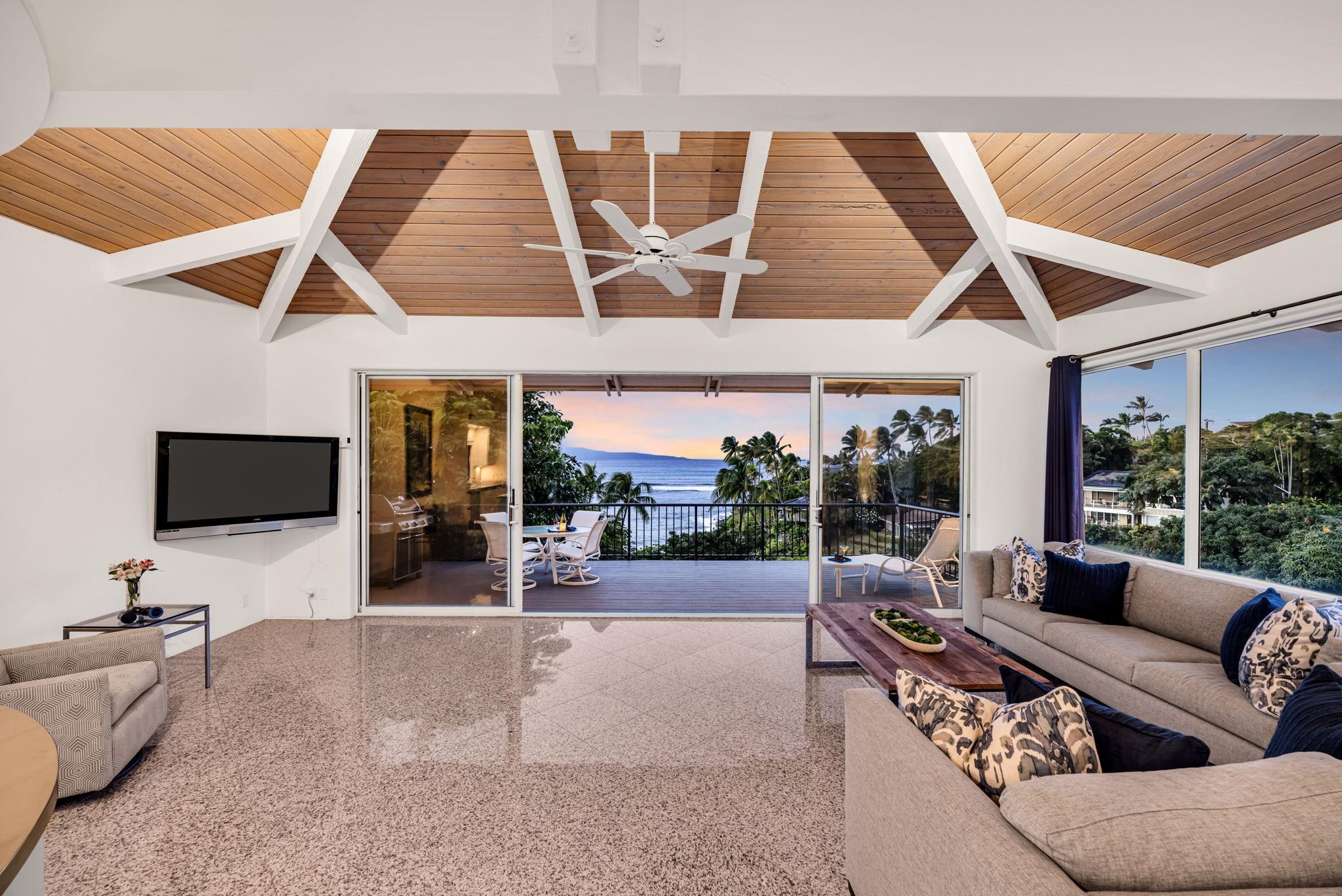5045 Lower Honoapiilani Road, Unit 9 Lahaina, HI 96761 - Photo 14 of 50 a living room with furniture a flat screen tv and a large window