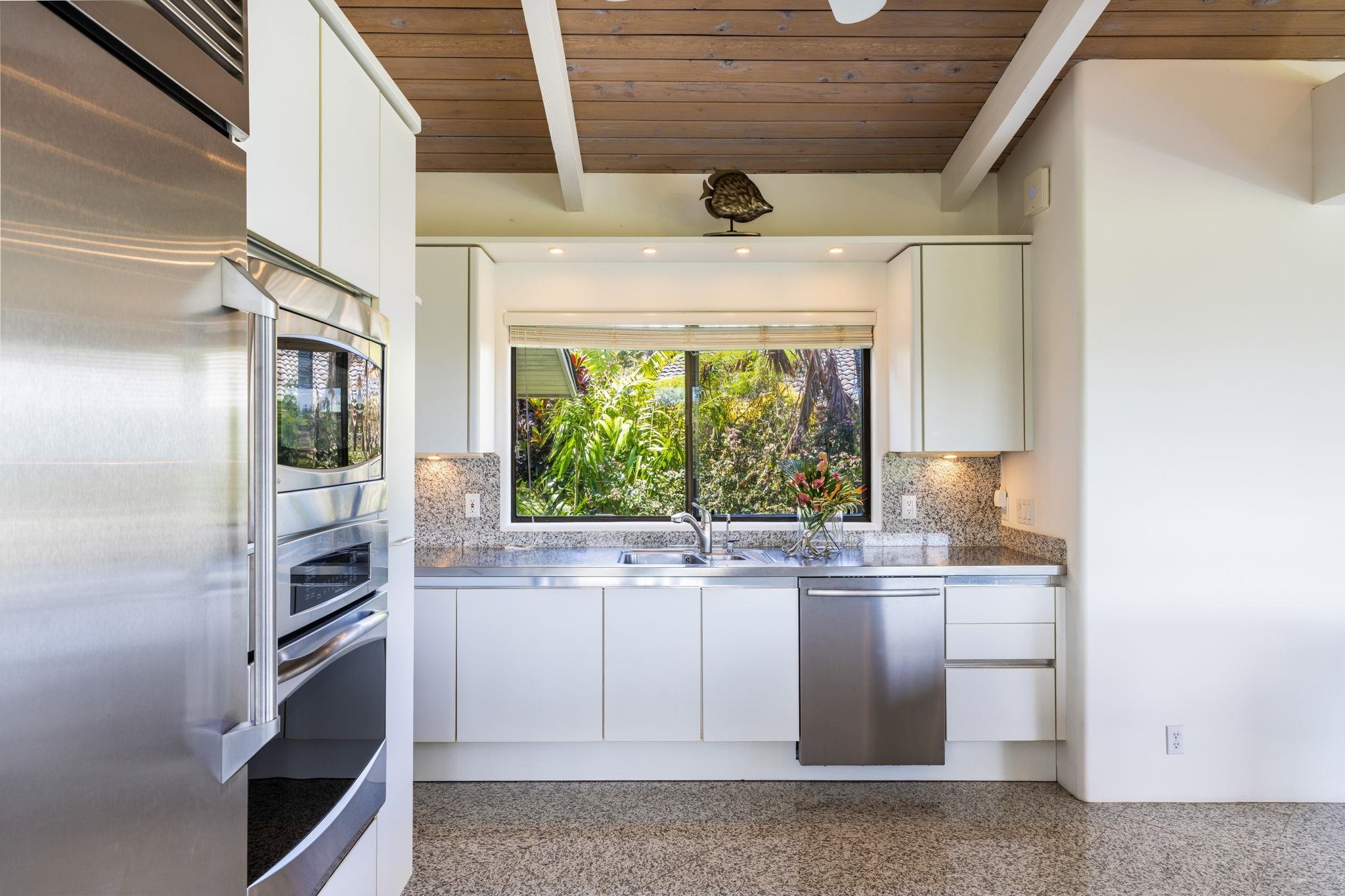 5045 Lower Honoapiilani Road, Unit 9 Lahaina, HI 96761 - Photo 20 of 50 a kitchen with a sink a window and cabinets