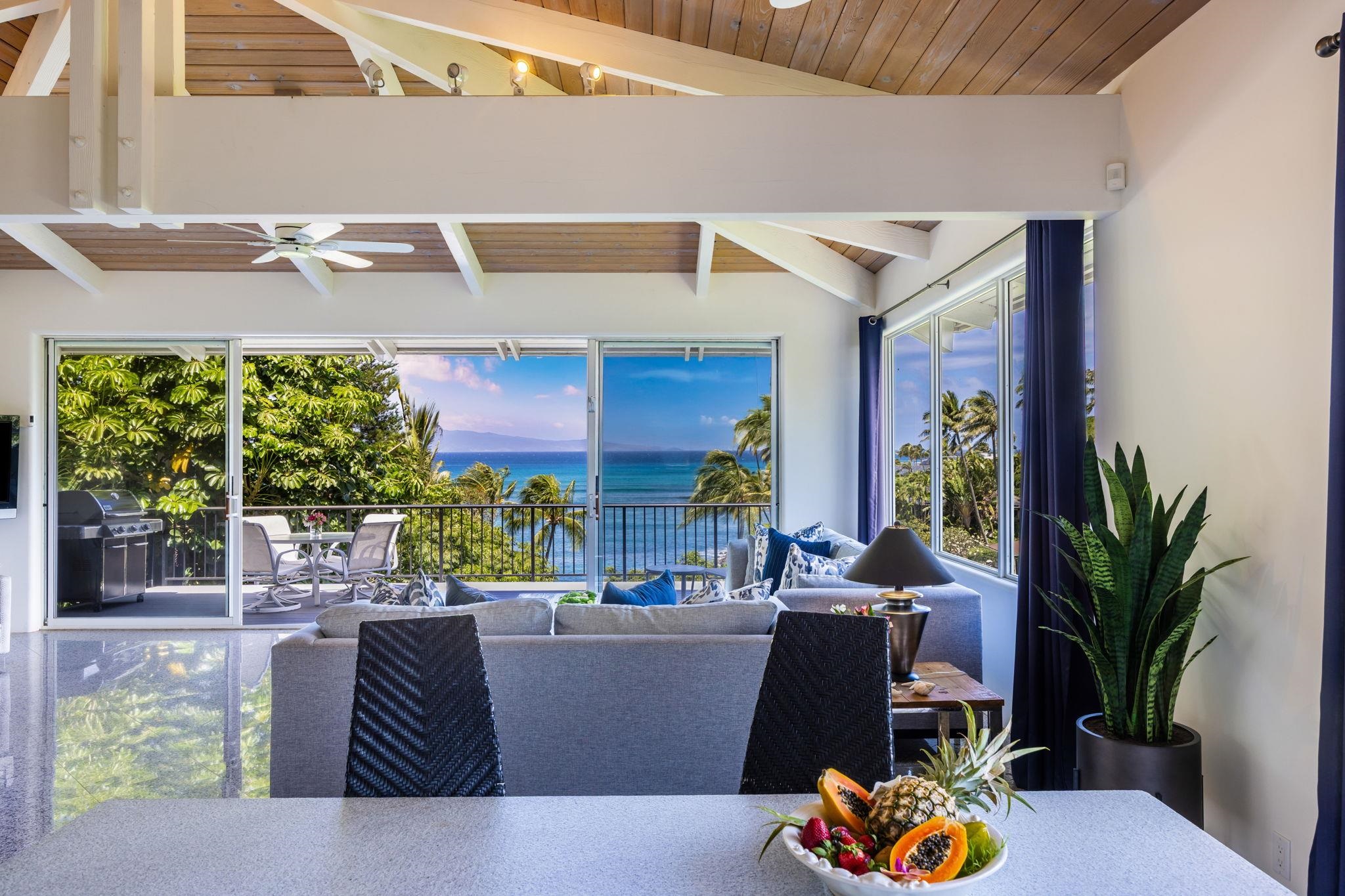 5045 Lower Honoapiilani Road, Unit 9 Lahaina, HI 96761 - Photo 23 of 50 a living room with furniture and a potted plant