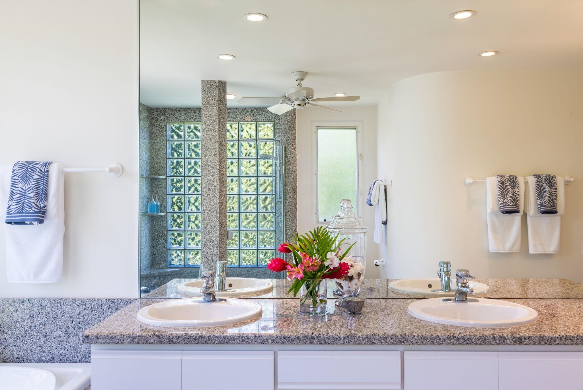 5045 Lower Honoapiilani Road, Unit 9 Lahaina, HI 96761 - Photo 29 of 50 a bathroom with double vanity sinks a vanity and a mirror