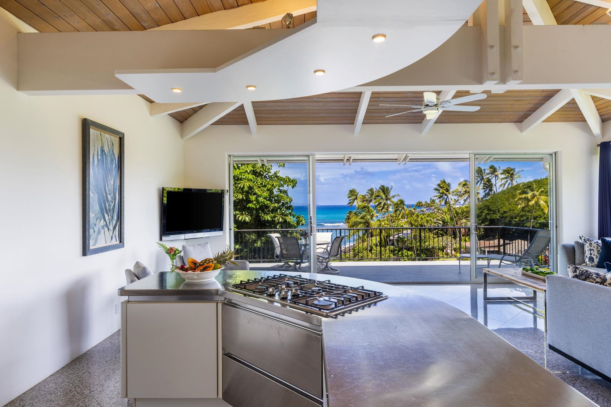 5045 Lower Honoapiilani Road, Unit 9 Lahaina, HI 96761 - Photo 3 of 50 a kitchen with stainless steel appliances kitchen island granite countertop a sink and a stove