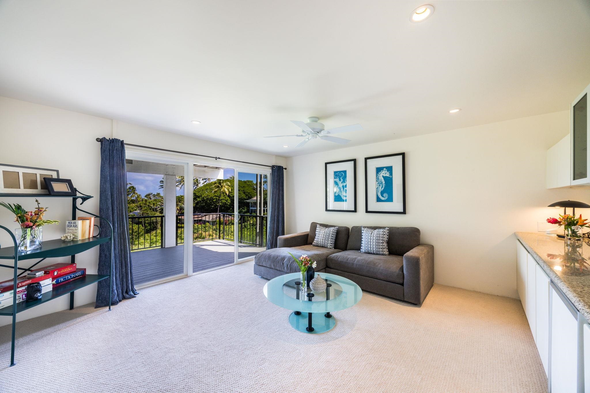 5045 Lower Honoapiilani Road, Unit 9 Lahaina, HI 96761 - Photo 35 of 50 a living room with furniture and a flat screen tv