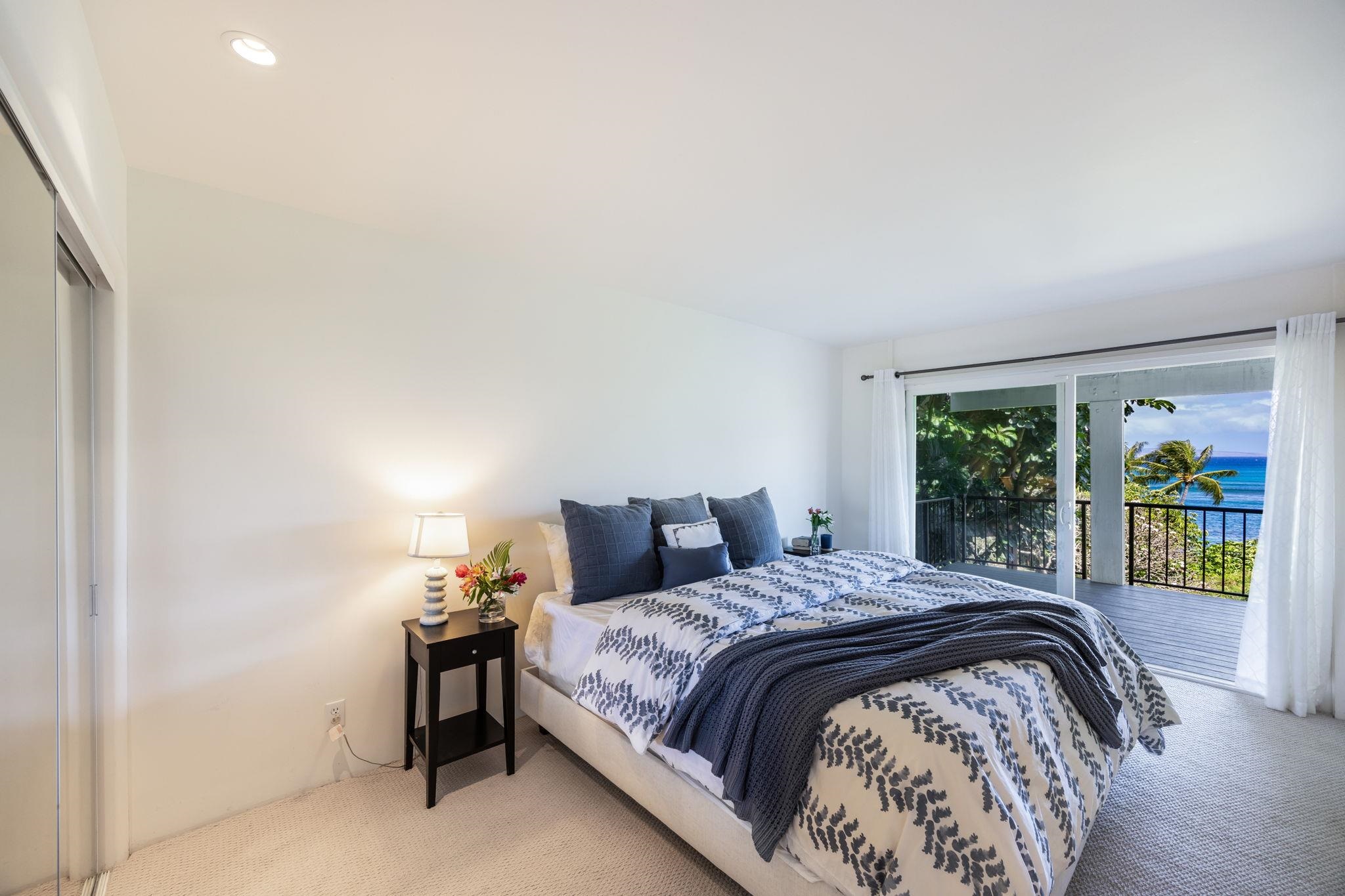 5045 Lower Honoapiilani Road, Unit 9 Lahaina, HI 96761 - Photo 36 of 50 a bedroom with a bed and a window