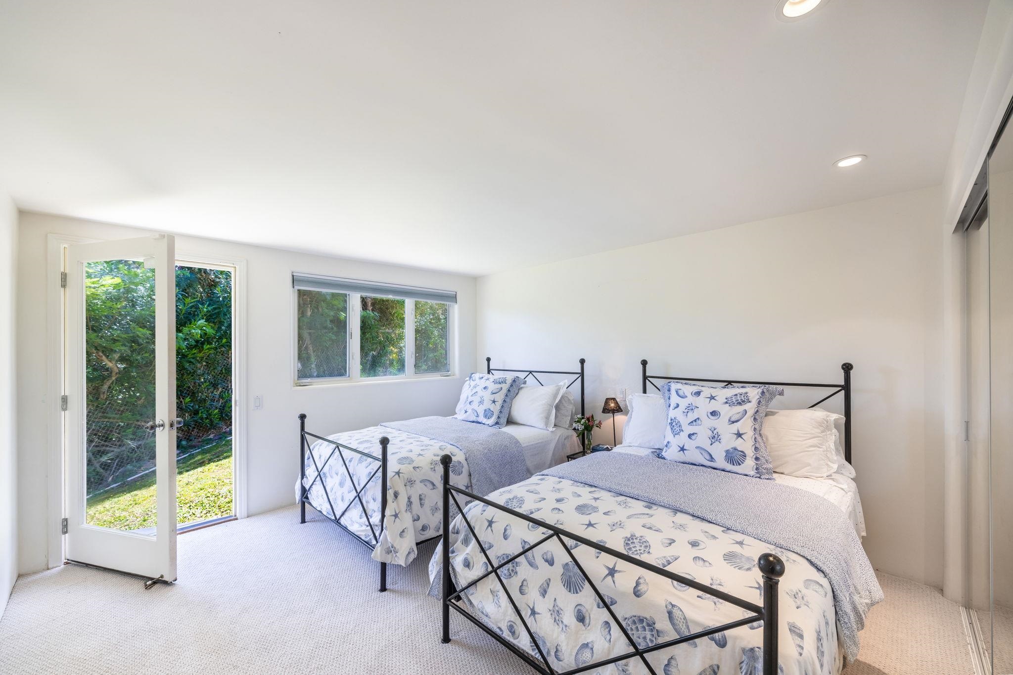 5045 Lower Honoapiilani Road, Unit 9 Lahaina, HI 96761 - Photo 39 of 50 a bedroom with a bed and a large window