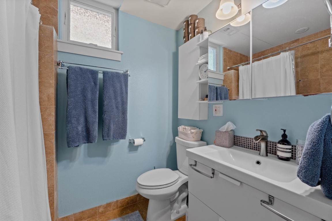 504 East 38th 1/2 Street Austin, TX 78751 - Photo 20 of 29 a bathroom with a sink a toilet and vanity