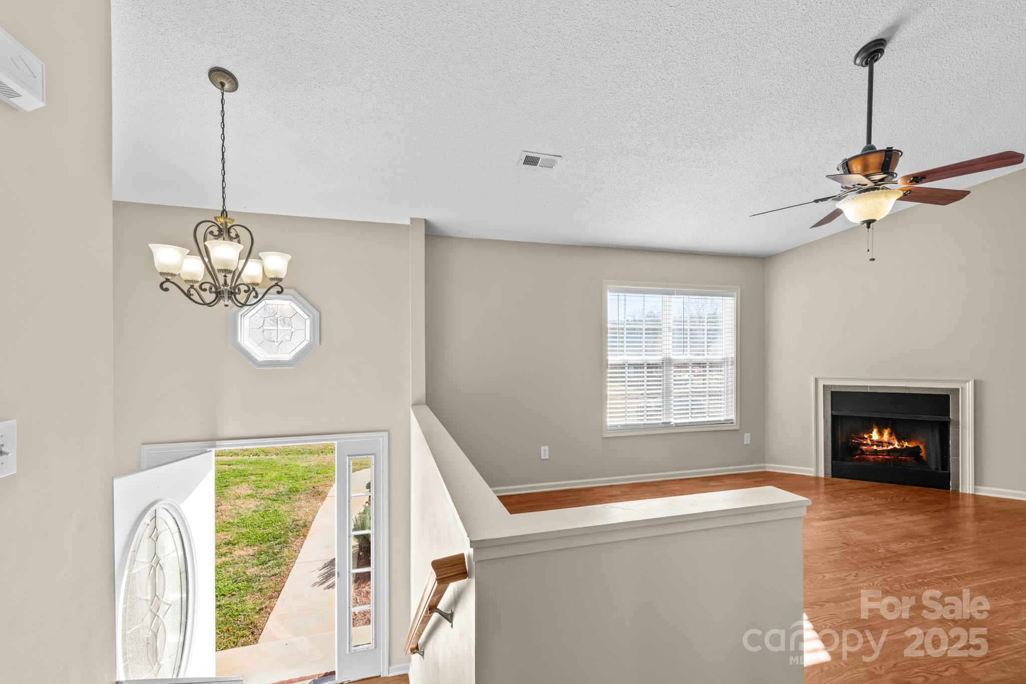 2244 Burris Road Conover, NC 28613 - Photo 17 of 38 a living room with a fireplace windows and a chandelier