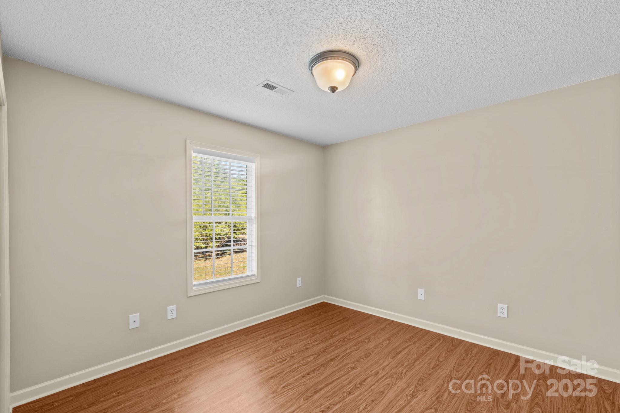 2244 Burris Road Conover, NC 28613 - Photo 23 of 38 an empty room with wooden floor and windows