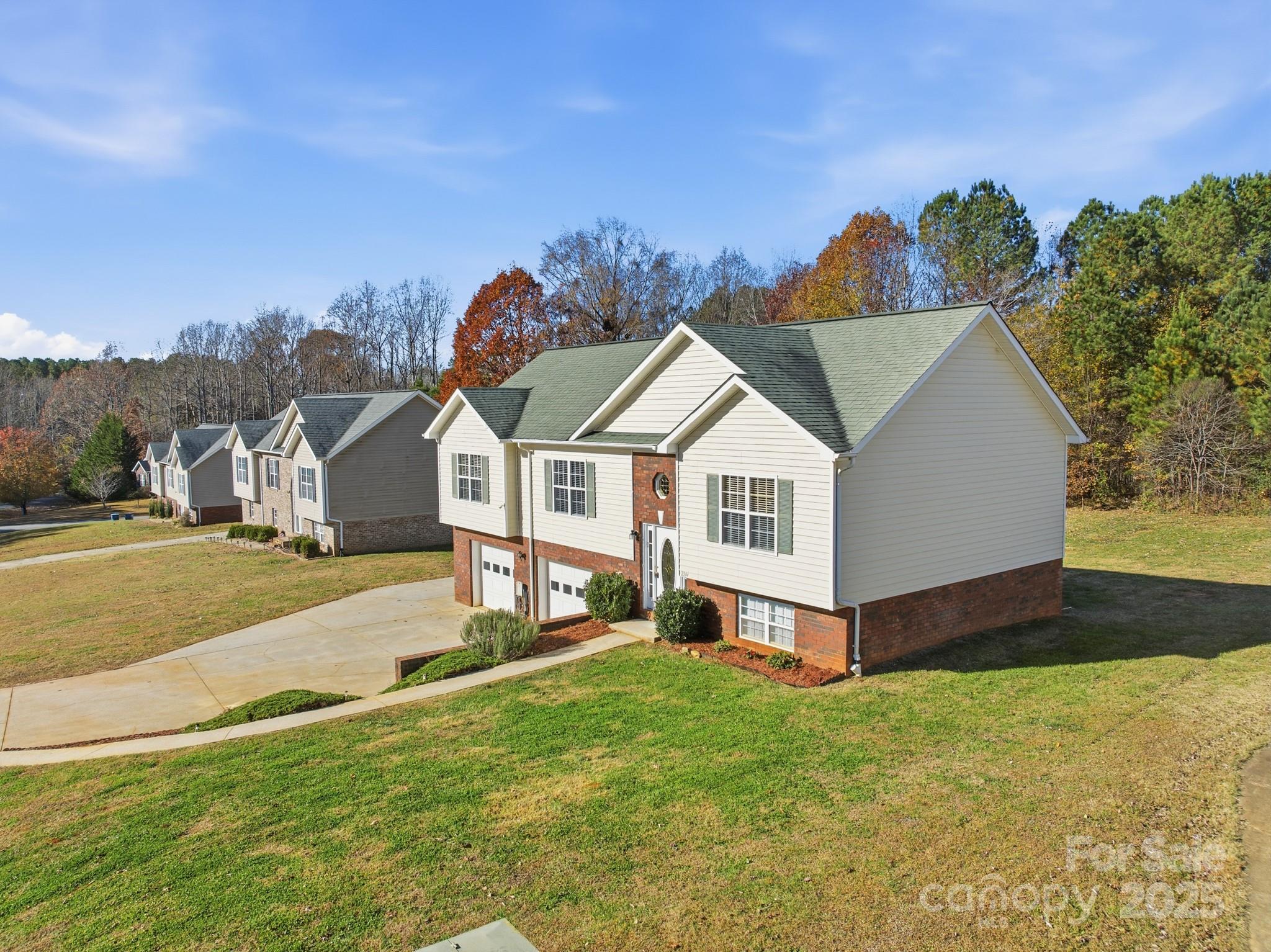 2244 Burris Road Conover, NC 28613 - Photo 4 of 38 a view of a white house with a big yard and large trees
