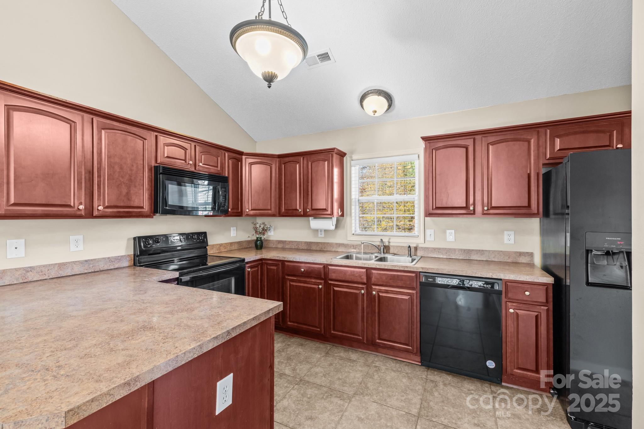 2244 Burris Road Conover, NC 28613 - Photo 5 of 38 a kitchen with stainless steel appliances granite countertop a sink stove microwave and refrigerator