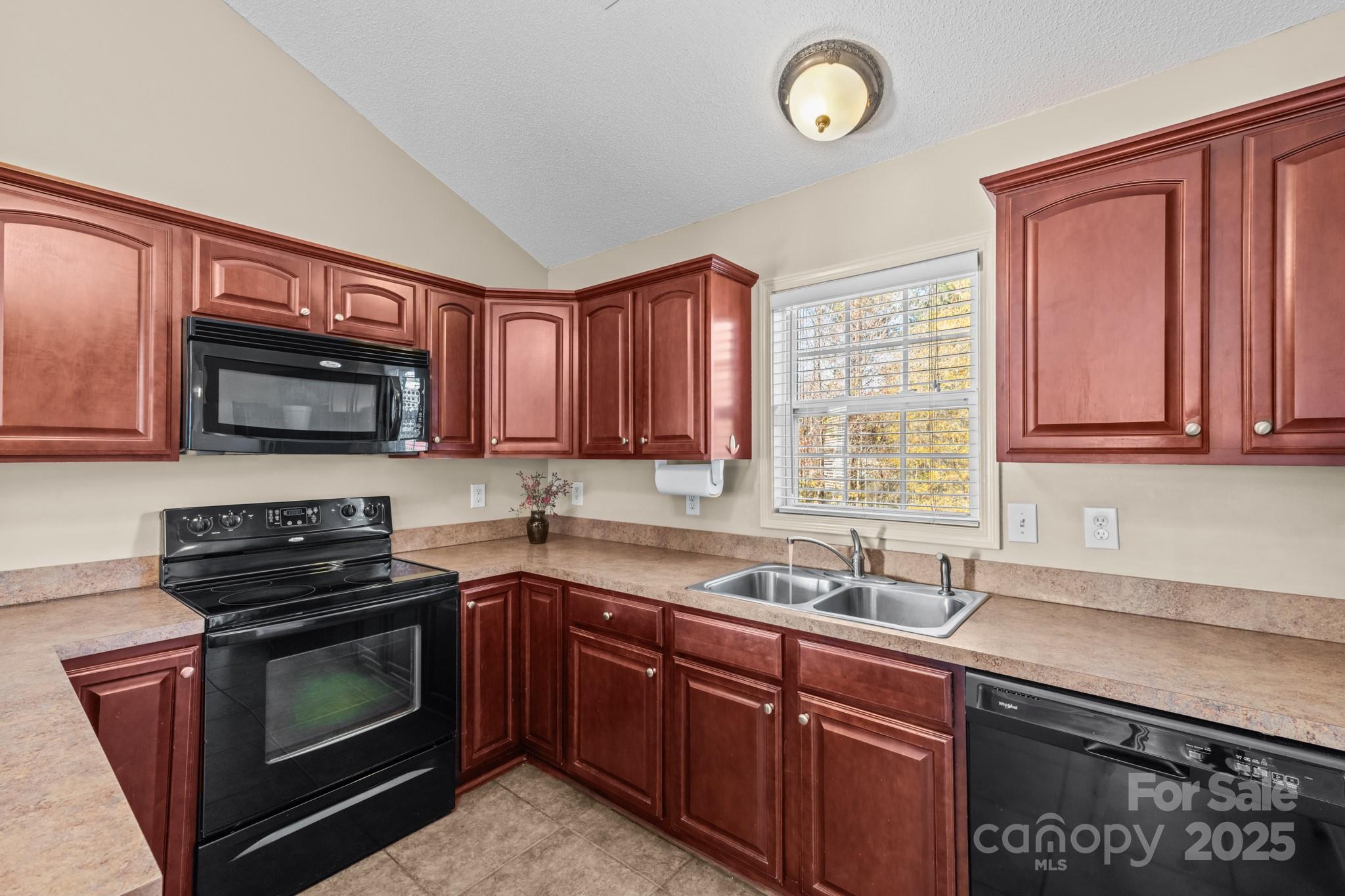 2244 Burris Road Conover, NC 28613 - Photo 6 of 38 a kitchen with granite countertop a stove top oven sink and cabinets