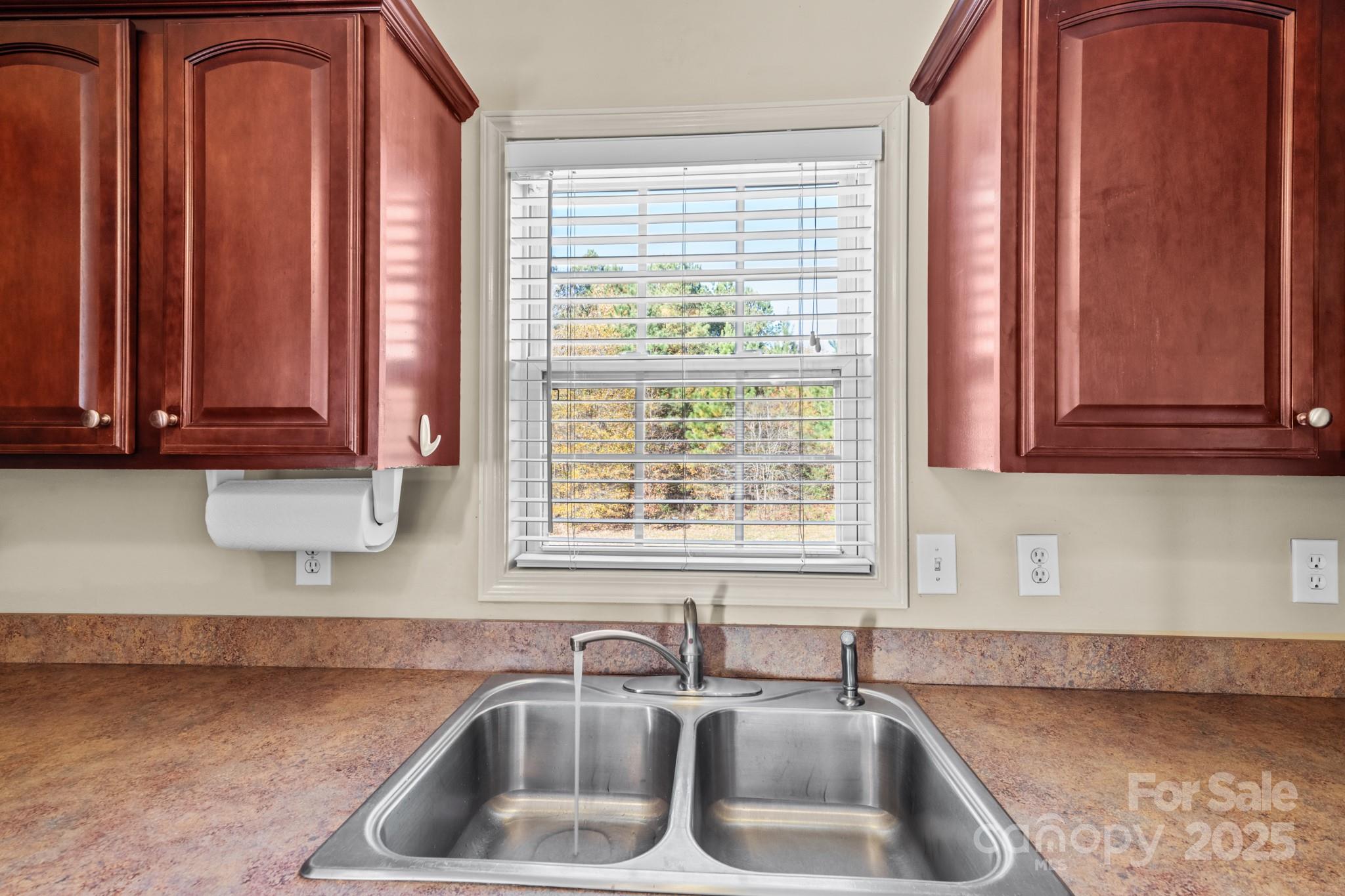 2244 Burris Road Conover, NC 28613 - Photo 7 of 38 a kitchen with stainless steel appliances wooden cabinets a sink and a window