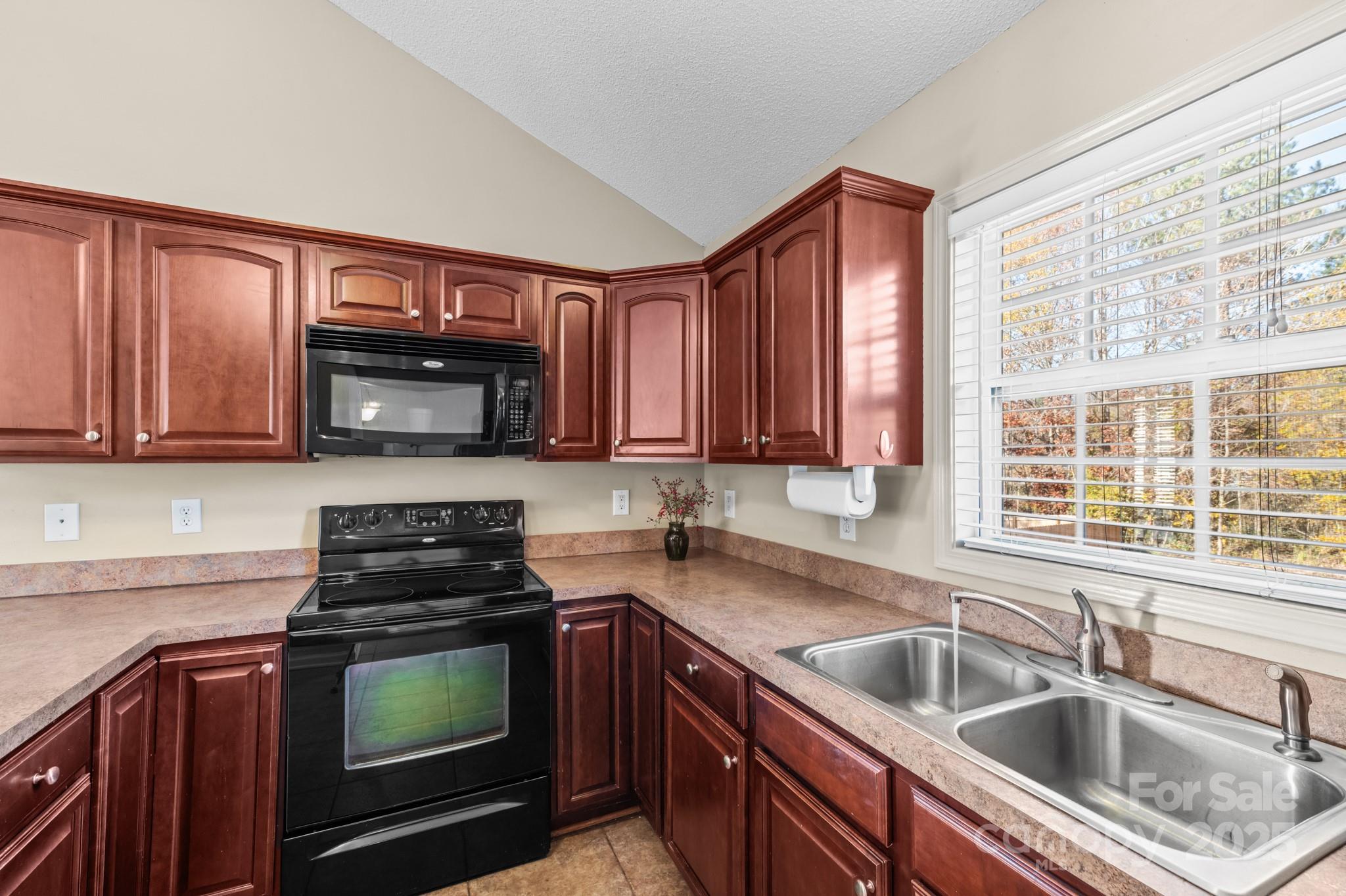 2244 Burris Road Conover, NC 28613 - Photo 8 of 38 a kitchen with granite countertop a sink a stove and cabinets