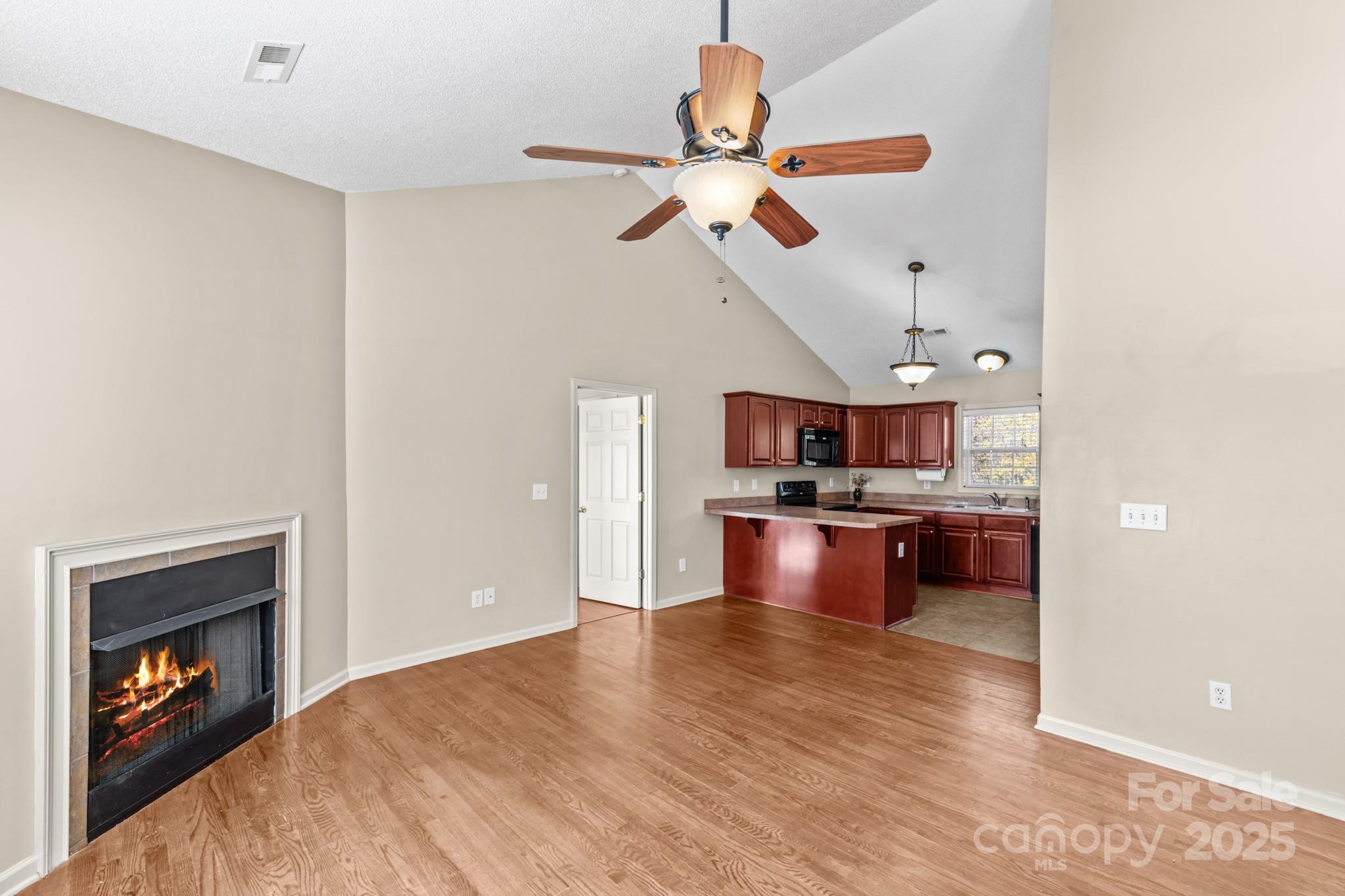 2244 Burris Road Conover, NC 28613 - Photo 9 of 38 a view of living room with kitchen island stainless steel appliances wooden floor and living room view