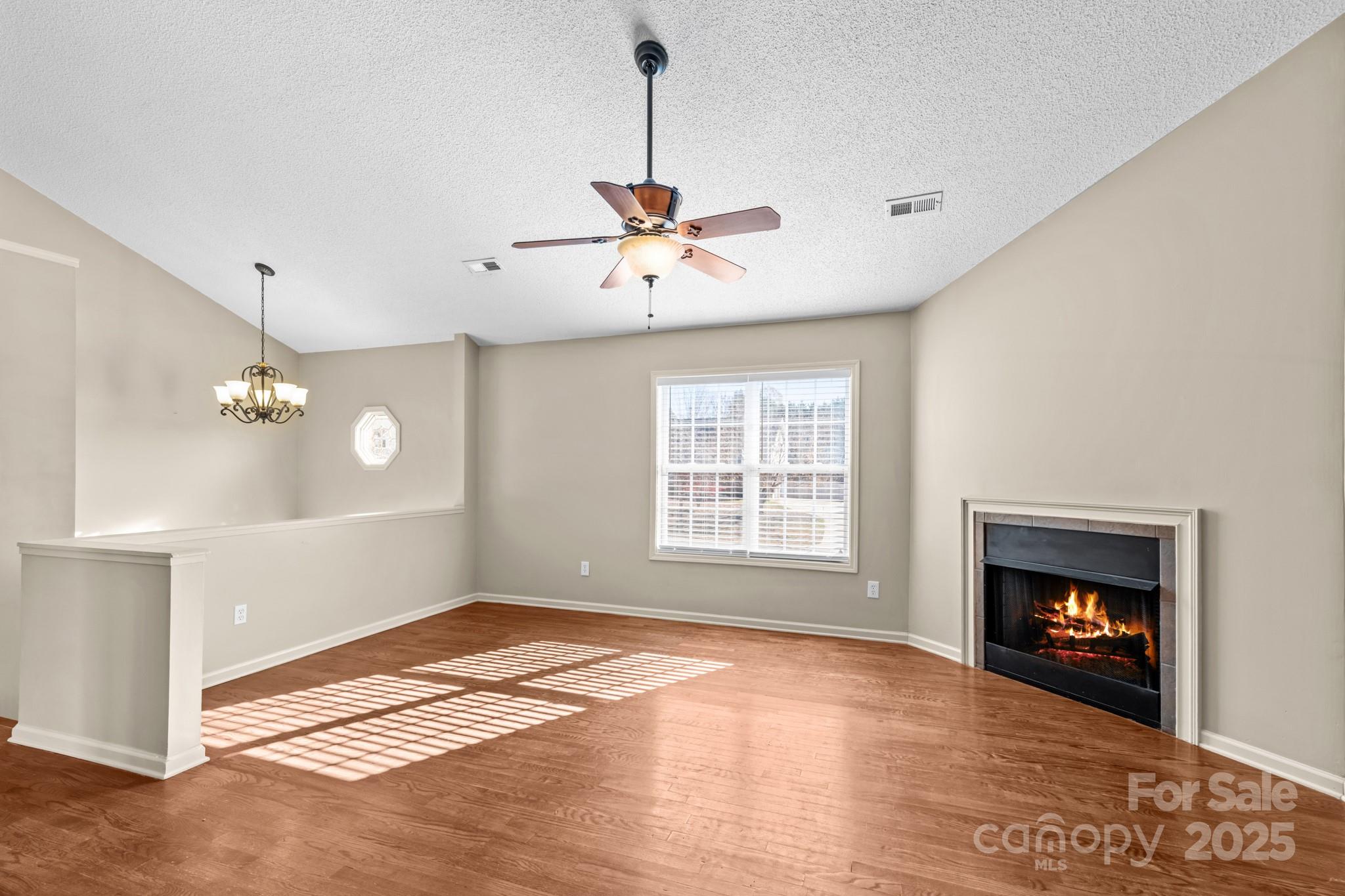 2244 Burris Road Conover, NC 28613 - Photo 10 of 38 a view of an empty room with a fireplace and a window