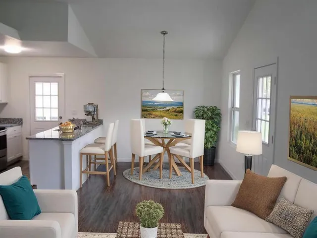 a living room with furniture a window and a table