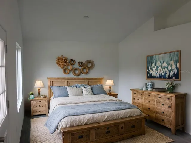 a bedroom with bed and window