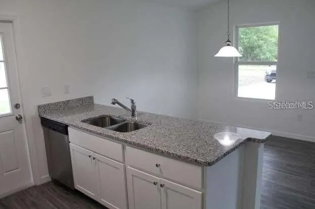 a kitchen with a sink and cabinets