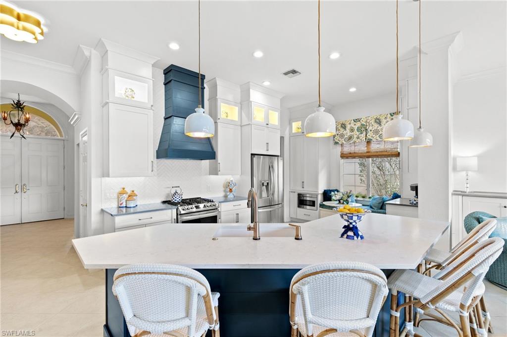 8536 Mallards Way Naples, FL 34114 - Photo 11 of 49 a kitchen with a dining table chairs and sink