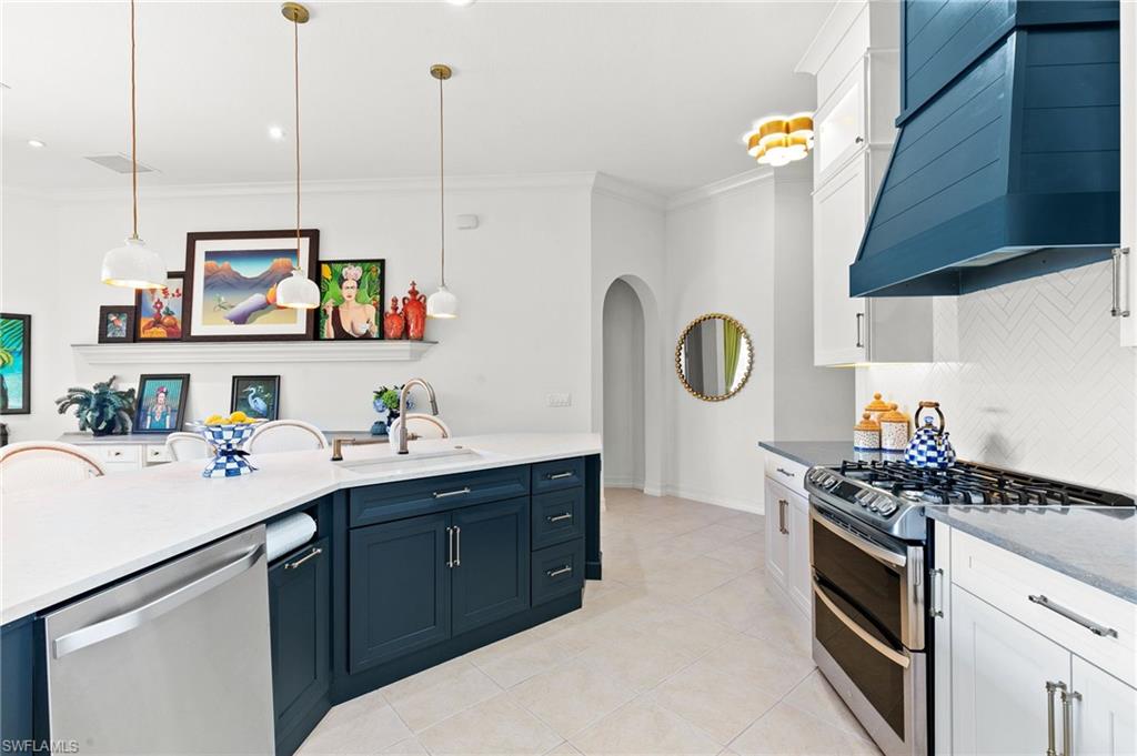 8536 Mallards Way Naples, FL 34114 - Photo 14 of 49 a kitchen with stainless steel appliances granite countertop a sink and a stove