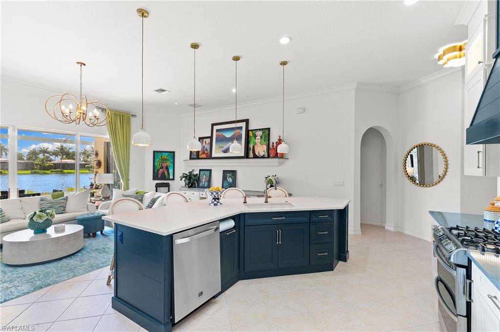 8536 Mallards Way Naples, FL 34114 - Photo 18 of 49 a large white kitchen with a sink and living room view