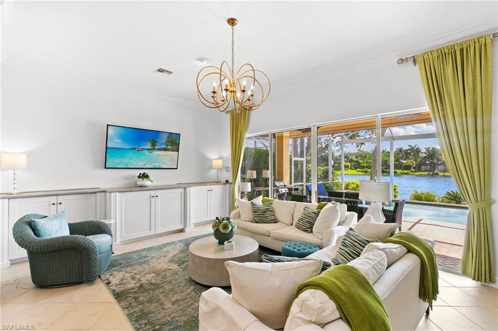 8536 Mallards Way Naples, FL 34114 - Photo 19 of 49 a living room with furniture chandelier and a large window