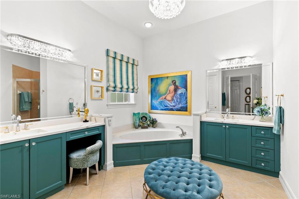 8536 Mallards Way Naples, FL 34114 - Photo 24 of 49 a spacious bathroom with a sink a large mirror and a bathtub