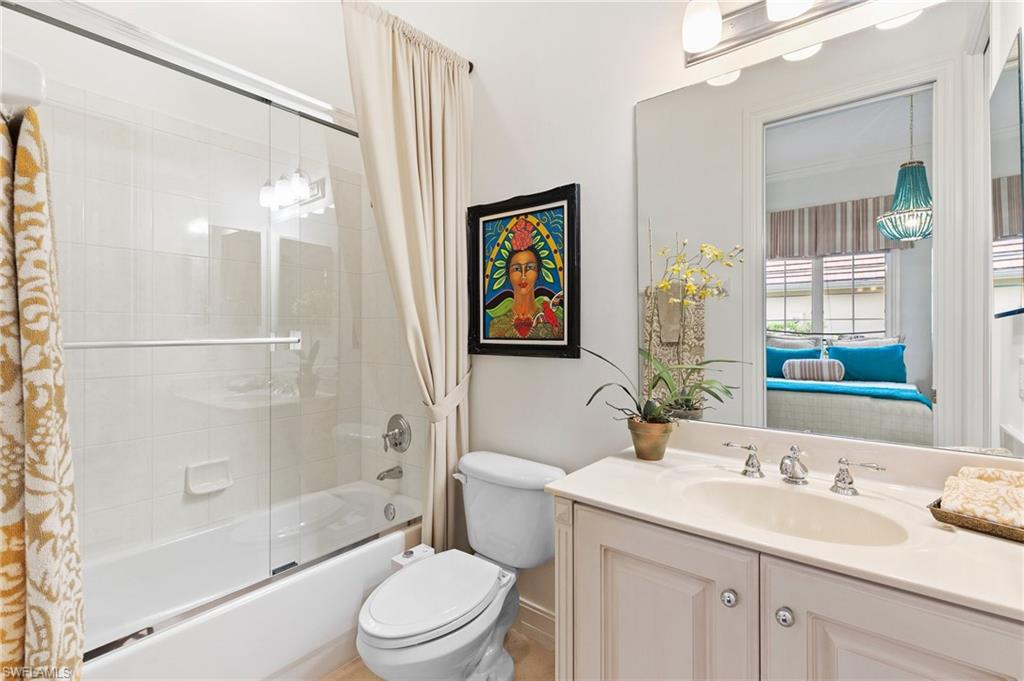 8536 Mallards Way Naples, FL 34114 - Photo 28 of 49 a bathroom with a granite countertop sink toilet and shower