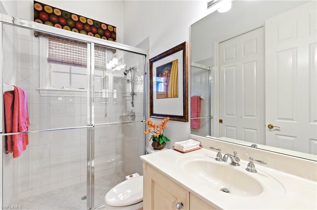 8536 Mallards Way Naples, FL 34114 - Photo 29 of 49 a bathroom with a sink vanity granite and a mirror