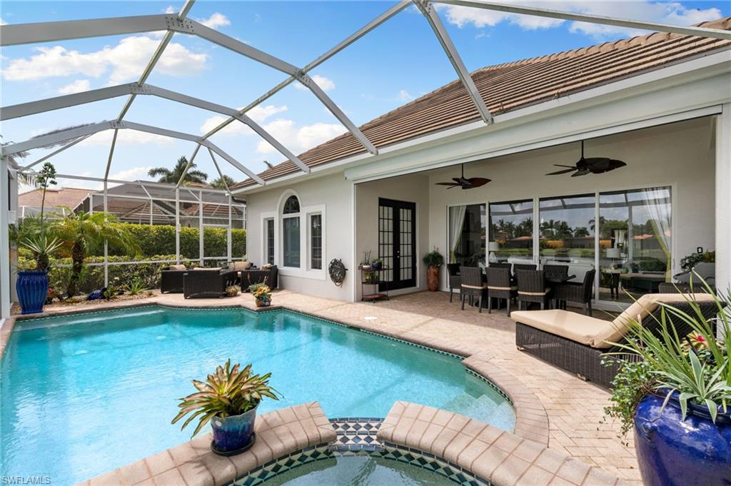 8536 Mallards Way Naples, FL 34114 - Photo 32 of 49 a view of a swimming pool with couches chairs and potted plants