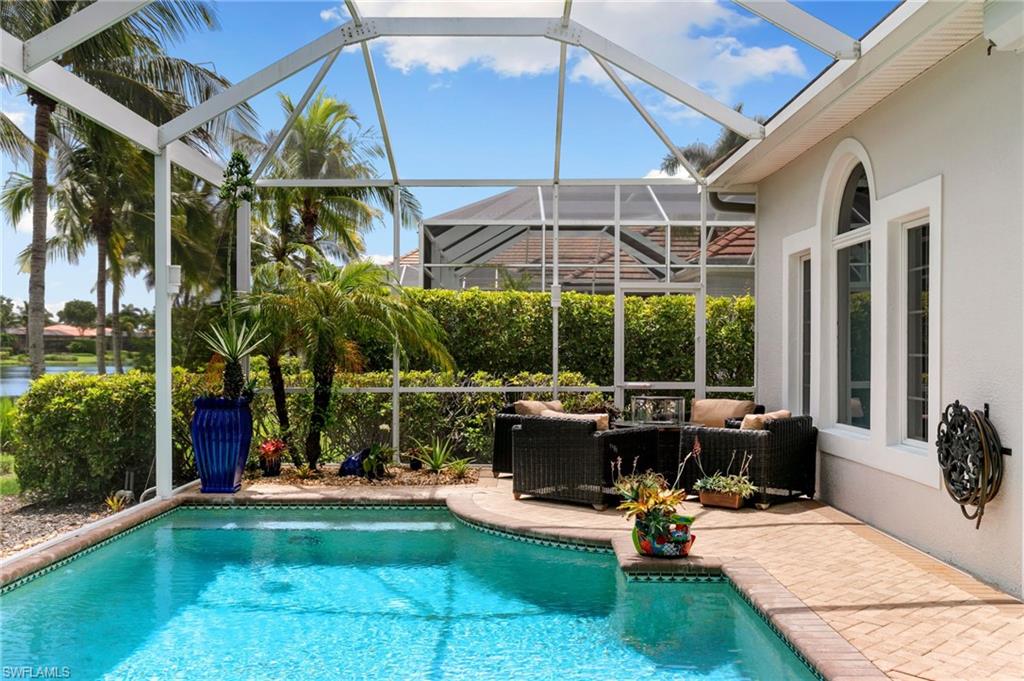 8536 Mallards Way Naples, FL 34114 - Photo 33 of 49 a view of a patio with a table and chairs under an umbrella