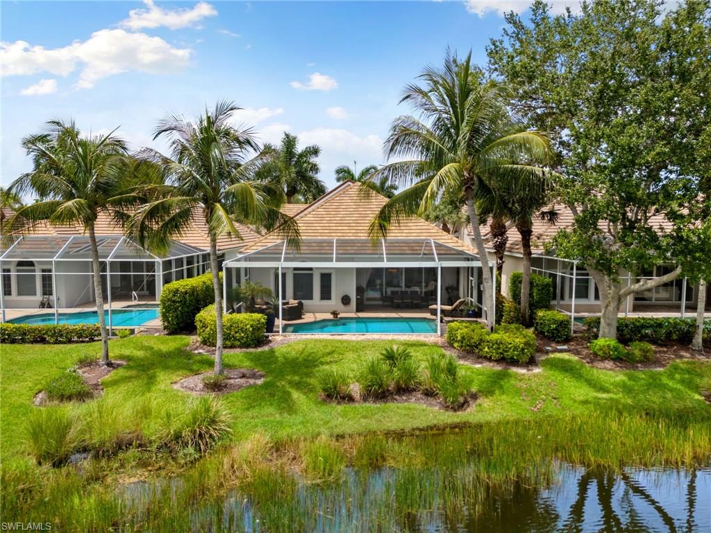 8536 Mallards Way Naples, FL 34114 - Photo 39 of 49 a view of a house with a big yard and potted plants and large trees
