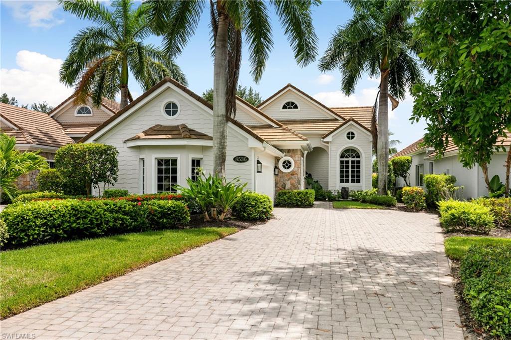 8536 Mallards Way Naples, FL 34114 - Photo 4 of 49 a view of a white house with a yard and palm trees