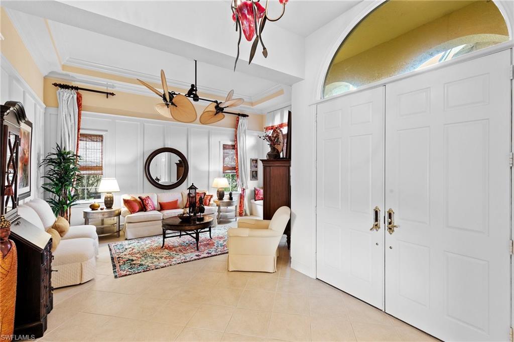 8536 Mallards Way Naples, FL 34114 - Photo 7 of 49 a living room with furniture a clock and white walls