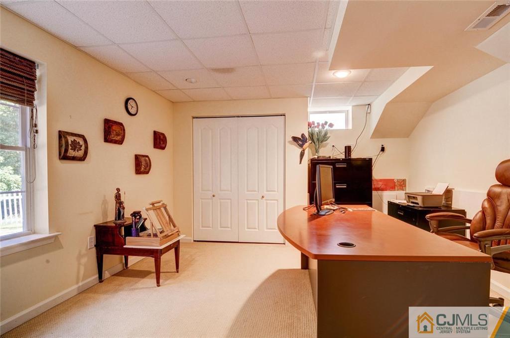 20 Timber Ridge Road North Brunswick, NJ 08902 - Photo 22 of 24 a living room with furniture a flat screen tv and a window