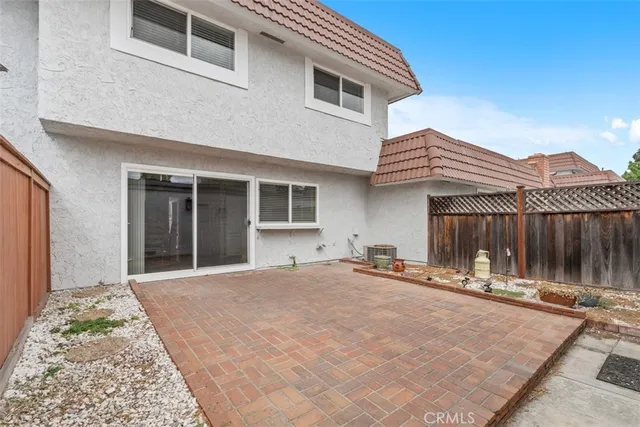 a backyard of a house with table and chairs