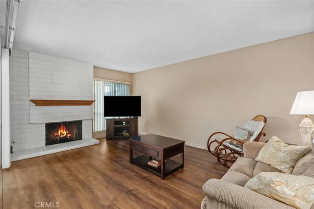 a living room with furniture flat screen tv and a fireplace
