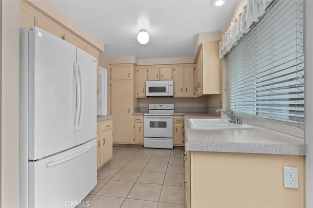 a kitchen with a stove sink and a refrigerator