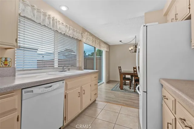 a kitchen with granite countertop a sink and cabinets