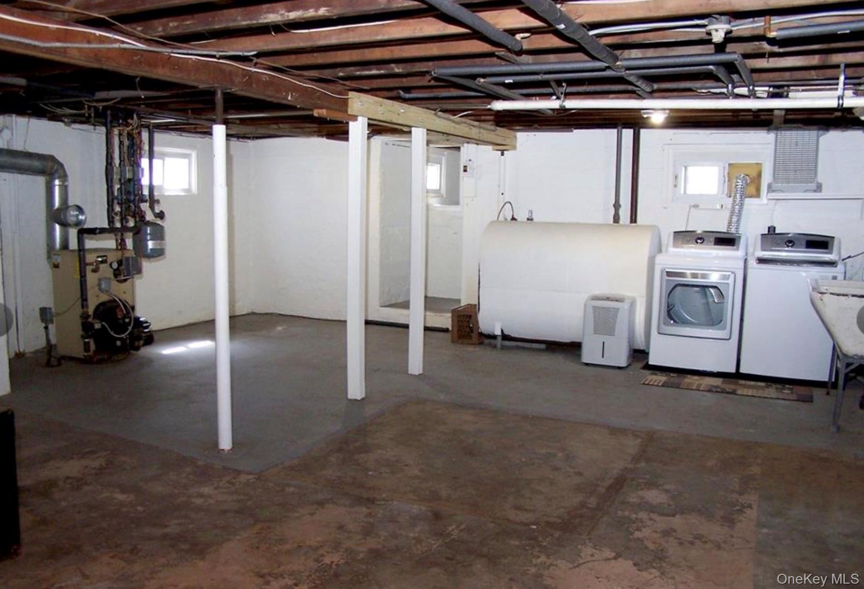 36 Columbine Road Rocky Point, NY 11778 - Photo 13 of 14 Below grade area featuring heating fuel, a heating unit, and washer and clothes dryer