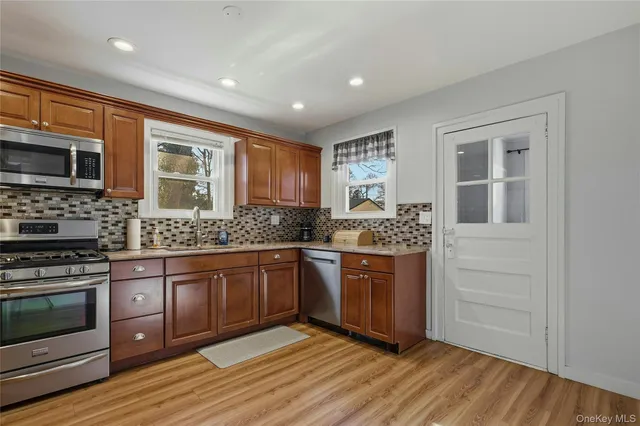 a kitchen with stainless steel appliances granite countertop a stove and a sink