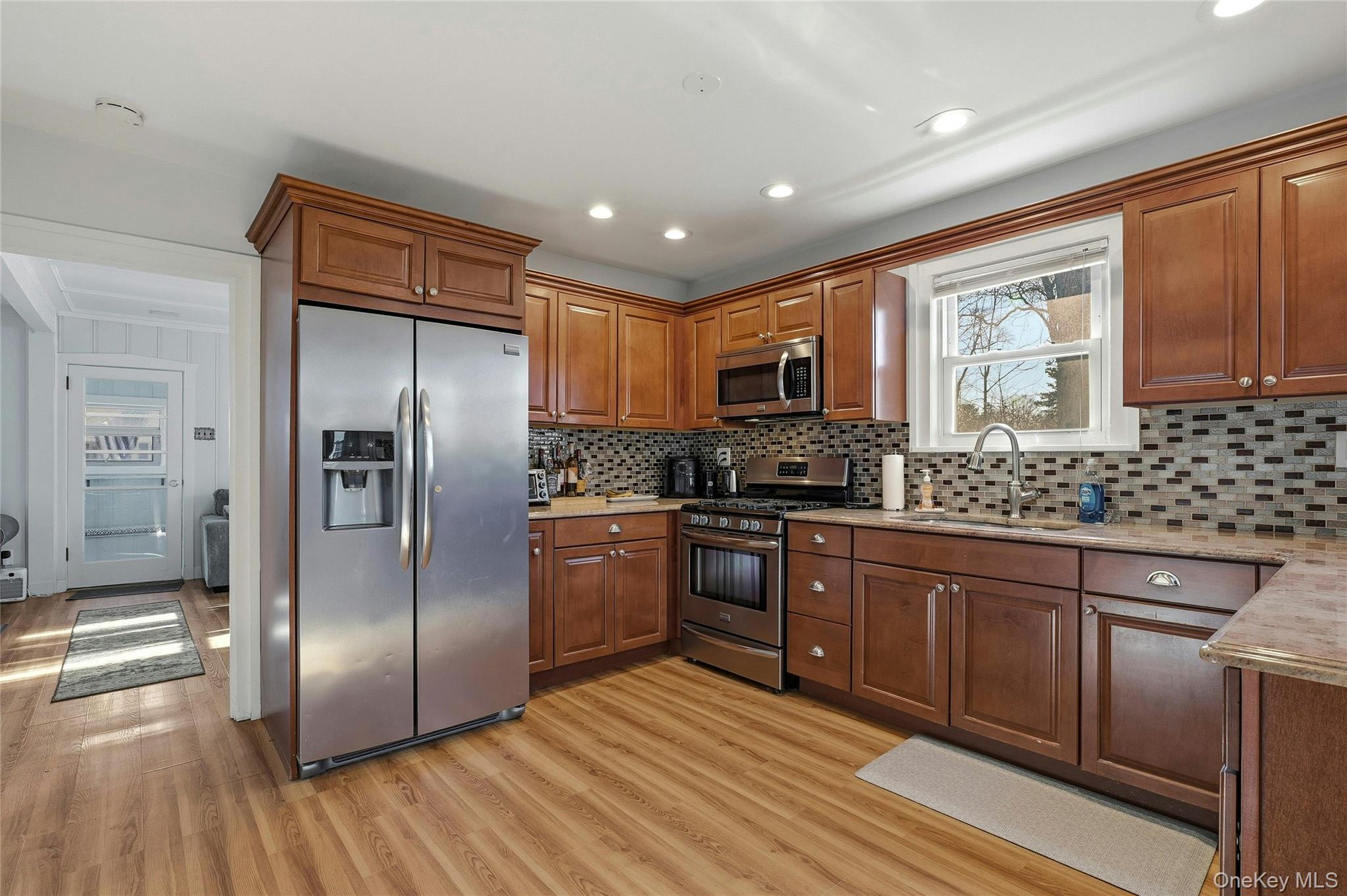 36 Columbine Road Rocky Point, NY 11778 - Photo 16 of 37 a kitchen with granite countertop stainless steel appliances a refrigerator sink and microwave