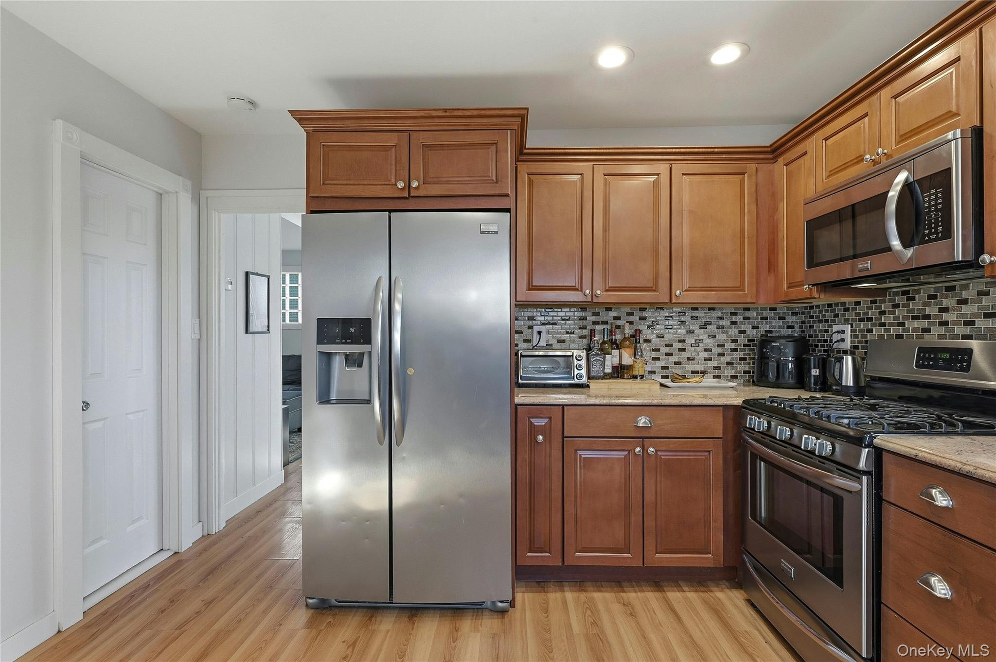 36 Columbine Road Rocky Point, NY 11778 - Photo 18 of 37 a kitchen with stainless steel appliances granite countertop a stove a refrigerator and a microwave