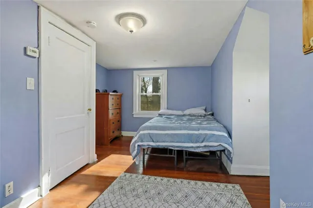 a bedroom with a bed and a rug