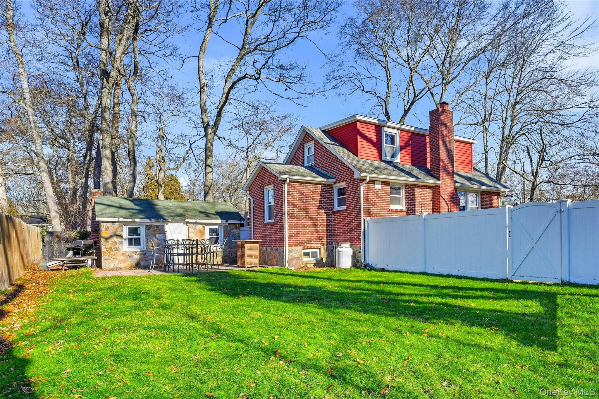 36 Columbine Road Rocky Point, NY 11778 - Photo 6 of 37 a front view of a building with a garden